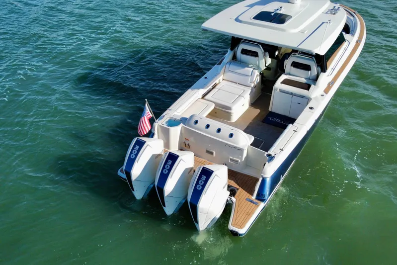  Yacht Photos Pics 2021 Chris-Craft Calypso 35 boat with triple outboard engines on open water.