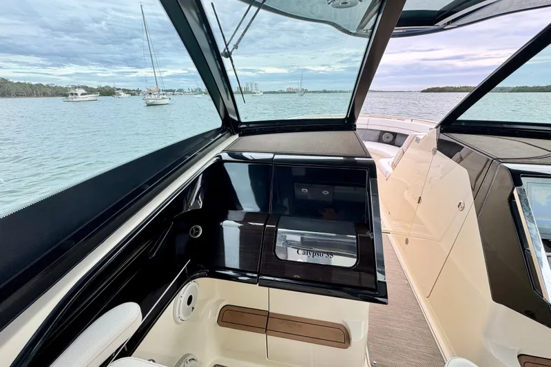  Yacht Photos Pics 2021 Chris-Craft Calypso 35 interior with sleek design and waterfront view.