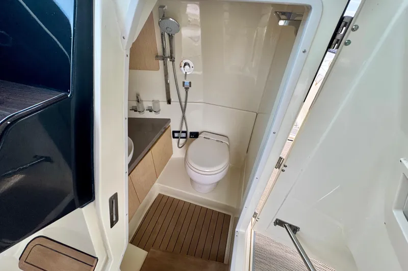  Yacht Photos Pics 2021 Chris-Craft Calypso 35 boat bathroom with modern fixtures and wooden flooring.