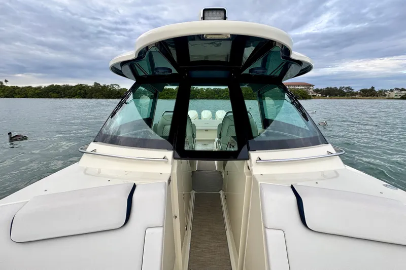  Yacht Photos Pics 2021 Chris-Craft Calypso 35 boat on calm water with scenic background.