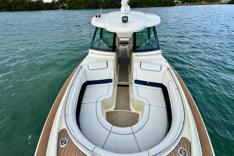  Yacht Photos Pics 2021 Chris-Craft Calypso 35 boat with elegant seating, cruising on calm waters.