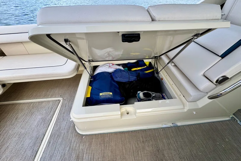 Yacht Photos Pics 2021 Chris-Craft Calypso 35 boat storage compartment with gear and accessories.