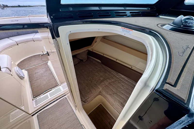  Yacht Photos Pics 2021 Chris-Craft Calypso 35 cabin interior with seating and bedding, overlooking water.