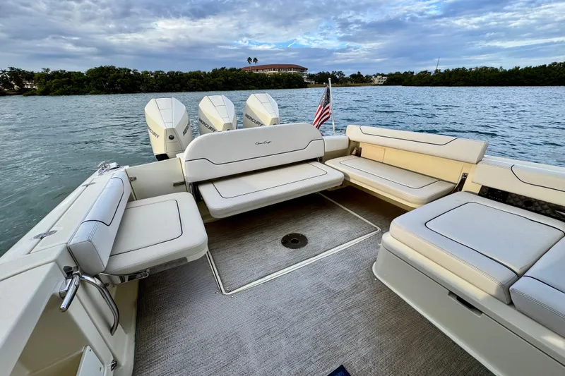  Yacht Photos Pics 2021 Chris-Craft Calypso 35 boat interior with seating and Mercury engines on a scenic waterway.