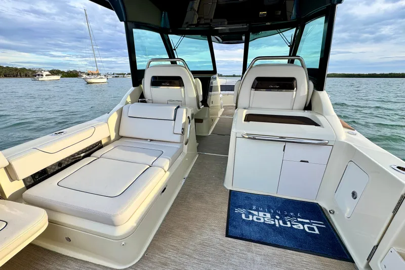  Yacht Photos Pics 2021 Chris-Craft Calypso 35 interior with luxurious seating and scenic water view.