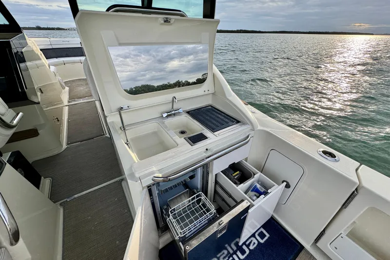  Yacht Photos Pics 2021 Chris-Craft Calypso 35 boat interior with kitchenette and ocean view.