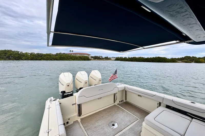  Yacht Photos Pics 2021 Chris-Craft Calypso 35 boat with triple Mercury engines on a calm lake.