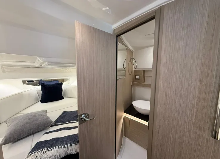  Yacht Photos Pics 2025 Jeanneau Leader 9.0 WA interior cabin with cozy bed and modern bathroom.