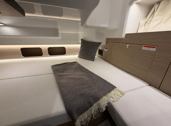  Yacht Photos Pics 2025 Jeanneau Leader 9.0 WA cabin interior with cozy bed and modern design.