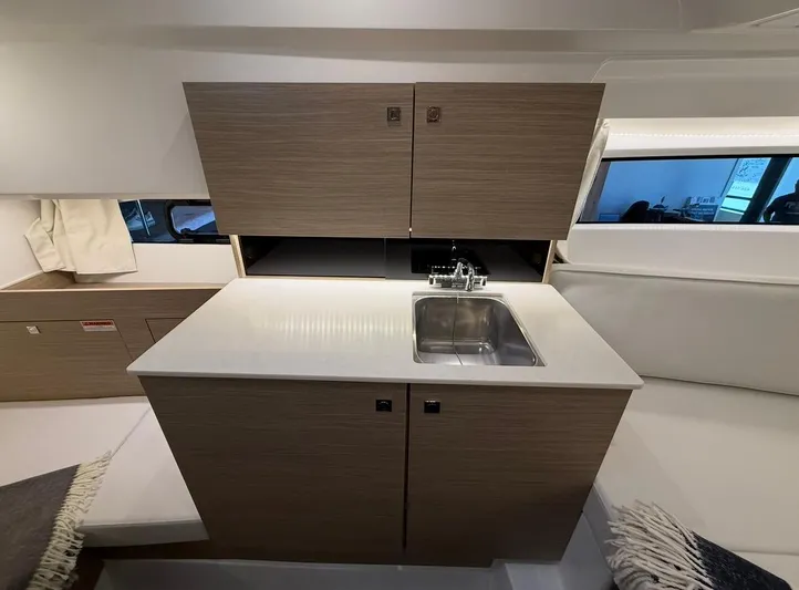 Yacht Photos Pics 2025 Jeanneau Leader 9.0 WA interior kitchen with sink and wooden cabinets.
