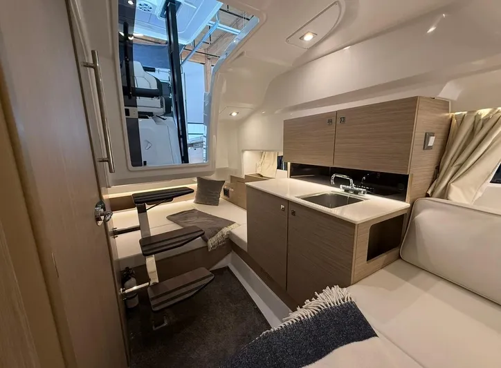  Yacht Photos Pics 2025 Jeanneau Leader 9.0 WA interior with modern kitchen and seating area.