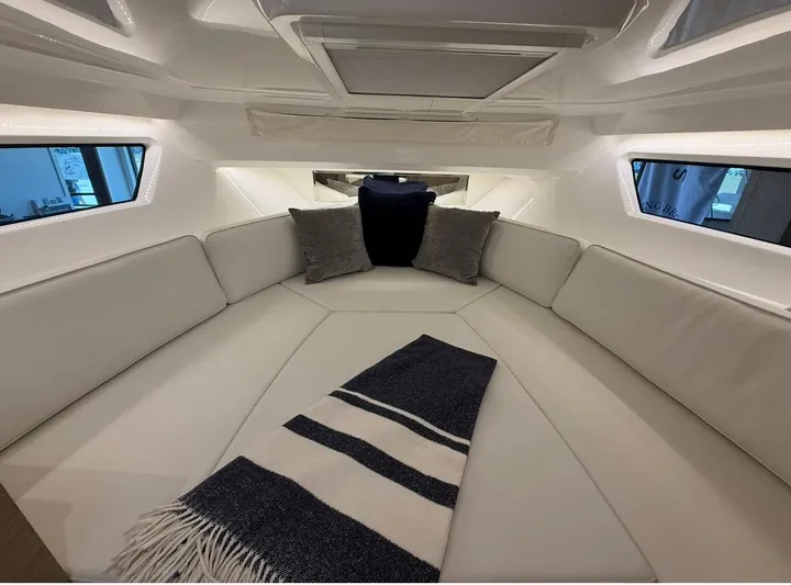  Yacht Photos Pics Luxurious interior of 2025 Jeanneau Leader 9.0 WA boat with cozy seating and cushions.
