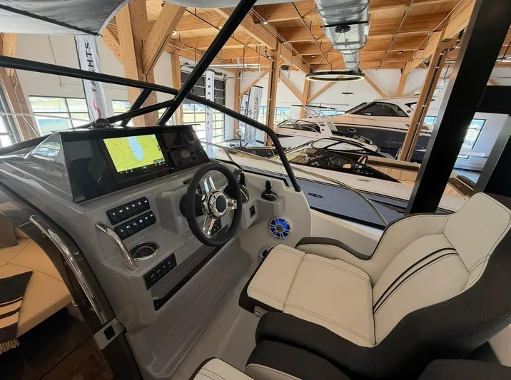  Yacht Photos Pics 2025 Jeanneau Leader 9.0 WA cockpit with modern navigation system and luxurious seating.