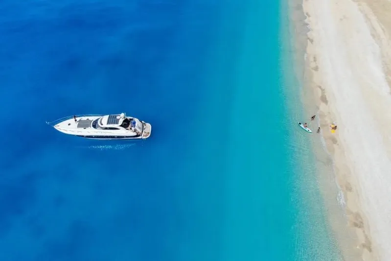  Yacht Photos Pics Aerial view of 2000 Sunseeker Predator 56 yacht near sandy beach and turquoise water.