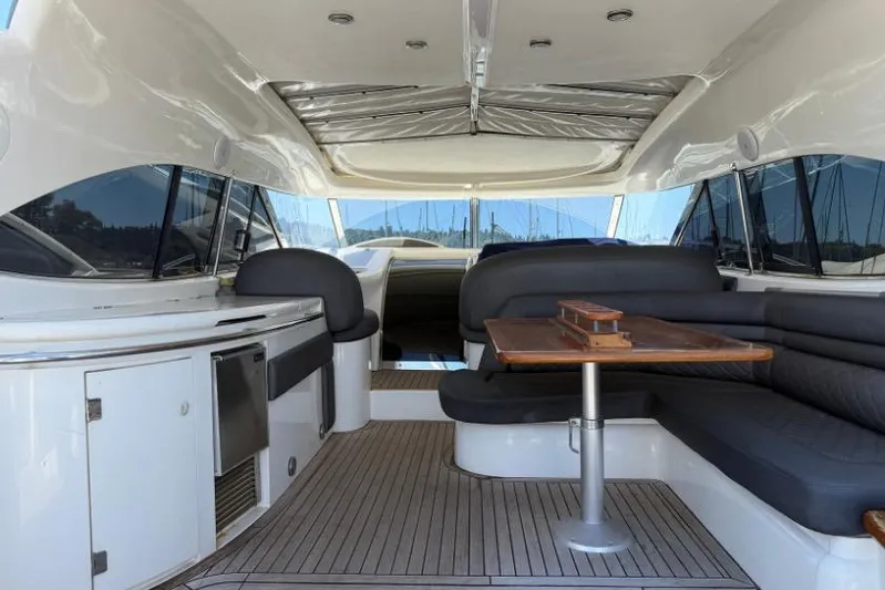  Yacht Photos Pics Interior of a 2000 Sunseeker Predator 56 yacht with sleek seating and wooden table.