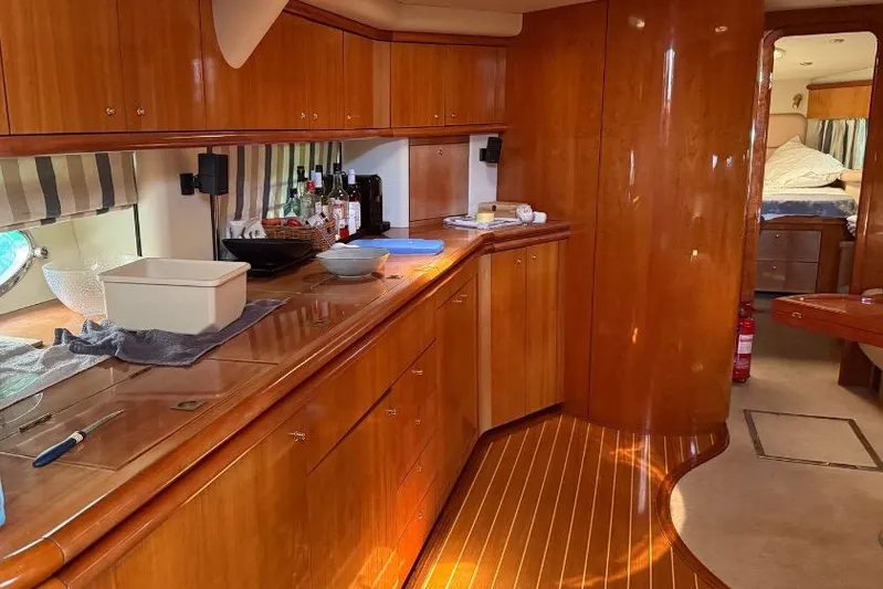  Yacht Photos Pics Luxurious interior of 2000 Sunseeker Predator 56 yacht with wooden cabinetry and modern amenities.