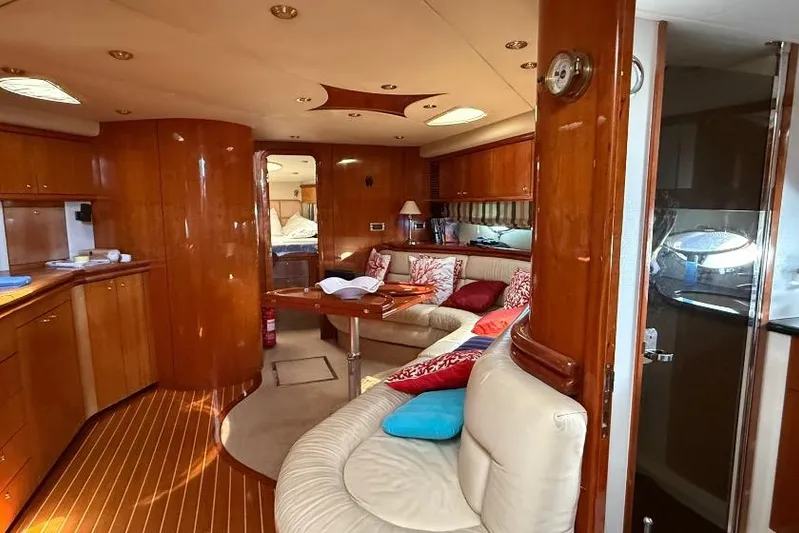  Yacht Photos Pics Luxurious interior of 2000 Sunseeker Predator 56 yacht with elegant wood finish and cozy seating.