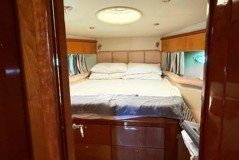  Yacht Photos Pics Luxurious bedroom interior of 2000 Sunseeker Predator 56 yacht with cozy bedding.