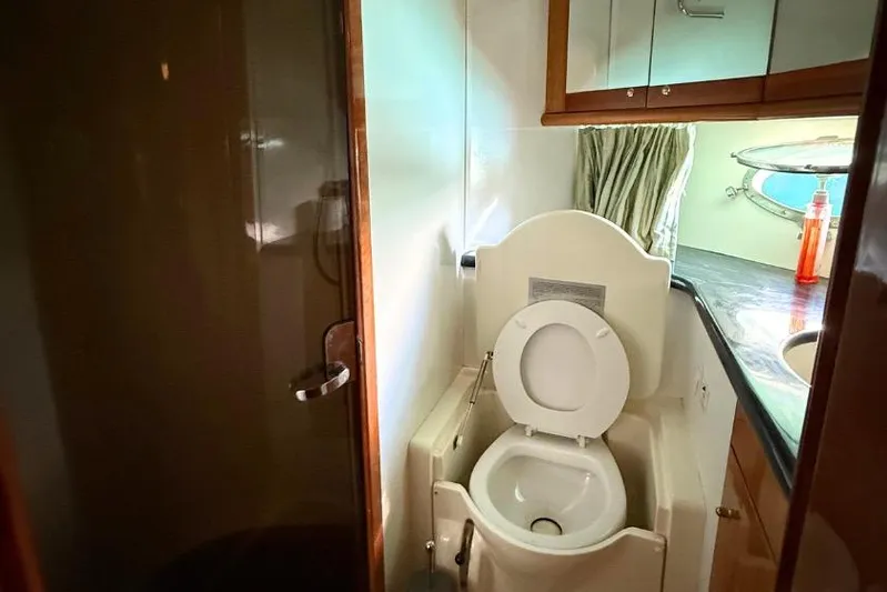  Yacht Photos Pics Bathroom interior of 2000 Sunseeker Predator 56 yacht, featuring toilet and shower.