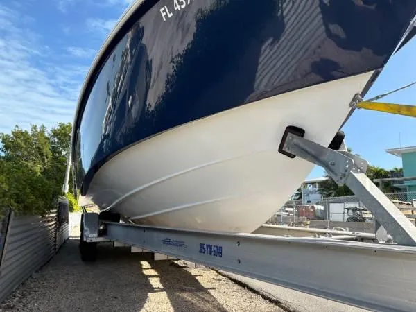  Yacht Photos Pics 2012 Everglades 325 Center Console boat on trailer, blue hull, sunny day.