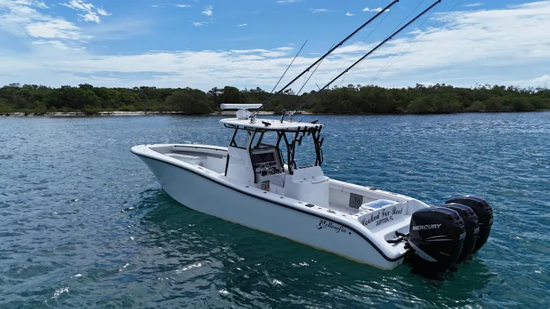  Yacht Photos Pics 2017 Yellowfin 36 Offshore boat with triple Mercury engines on blue water.
