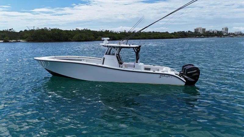  Yacht Photos Pics 2017 Yellowfin 36 Offshore boat on calm blue water, with fishing rods and Mercury engines.