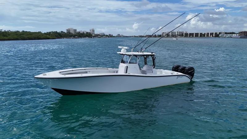  Yacht Photos Pics 2017 Yellowfin 36 Offshore boat on calm blue water, clear sky background.