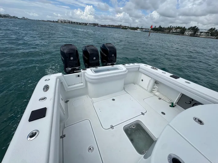  Yacht Photos Pics 2017 Yellowfin 36 Offshore boat with triple outboard engines on open water.