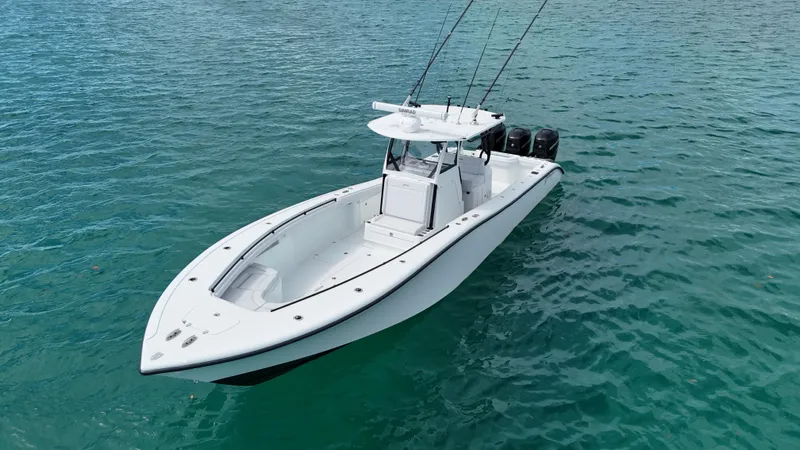  Yacht Photos Pics 2017 Yellowfin 36 Offshore boat on clear blue water, featuring triple outboard engines.