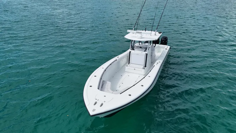  Yacht Photos Pics 2017 Yellowfin 36 Offshore boat on clear blue water, equipped for fishing.