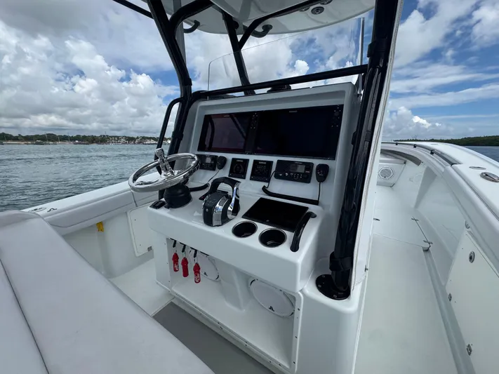  Yacht Photos Pics 2017 Yellowfin 36 Offshore boat cockpit with steering wheel and navigation equipment.