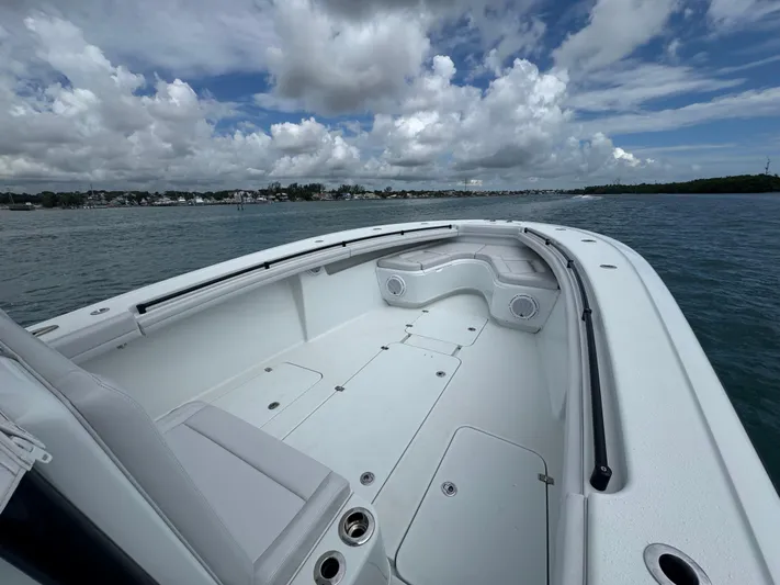  Yacht Photos Pics 2017 Yellowfin 36 Offshore boat on calm water under cloudy sky.