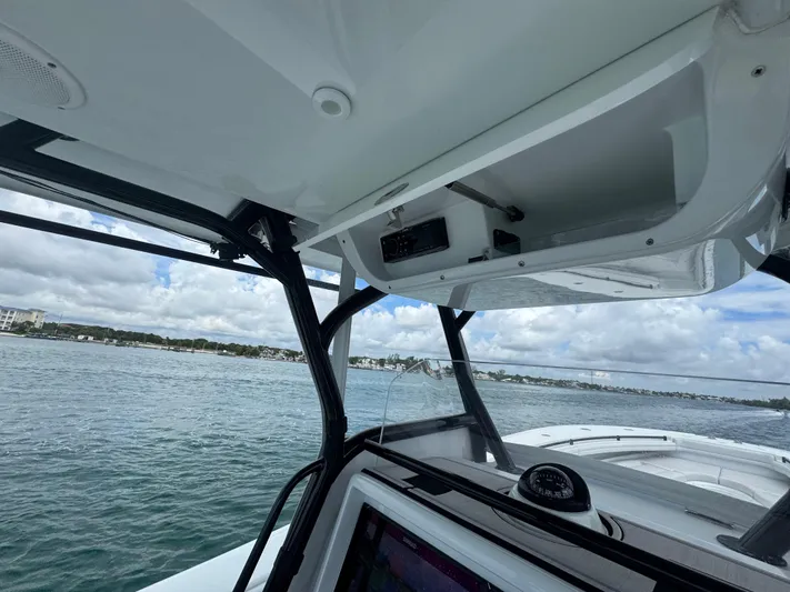  Yacht Photos Pics 2017 Yellowfin 36 Offshore boat interior with open storage compartment, ocean view in background.