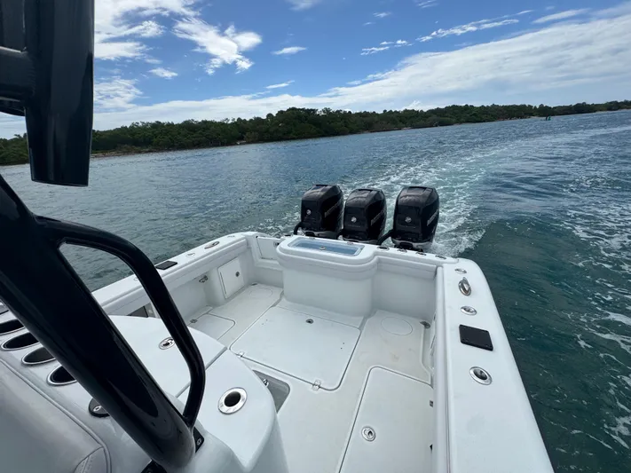  Yacht Photos Pics 2017 Yellowfin 36 Offshore boat with triple engines cruising on open water.