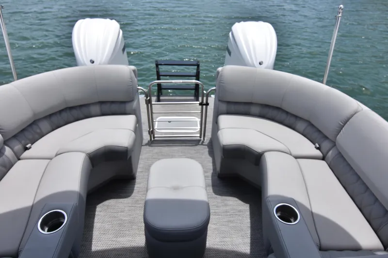  Yacht Photos Pics 2024 Bennington 27 QFB pontoon boat with luxurious seating on a calm lake.