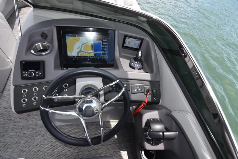  Yacht Photos Pics 2024 Bennington 27 QFB boat dashboard with navigation screen and controls.