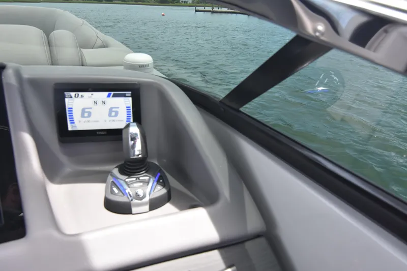  Yacht Photos Pics 2024 Bennington 27 QFB boat dashboard with control panel and water view.