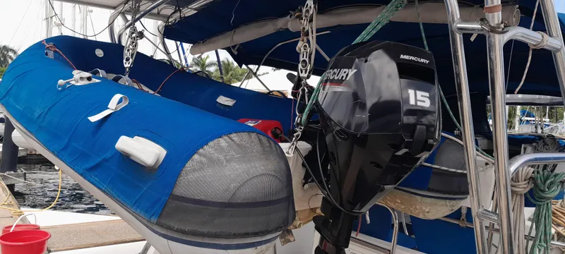 Picaro Yacht Photos Pics Beneteau Oceanis 473 sailboat with blue dinghy and Mercury outboard motor, 2005 model.