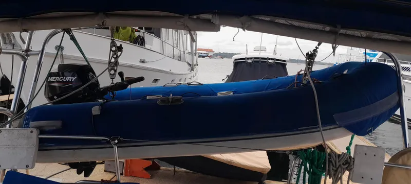 Picaro Yacht Photos Pics Blue inflatable boat on a Beneteau Oceanis 473, 2005 model, docked at a marina.