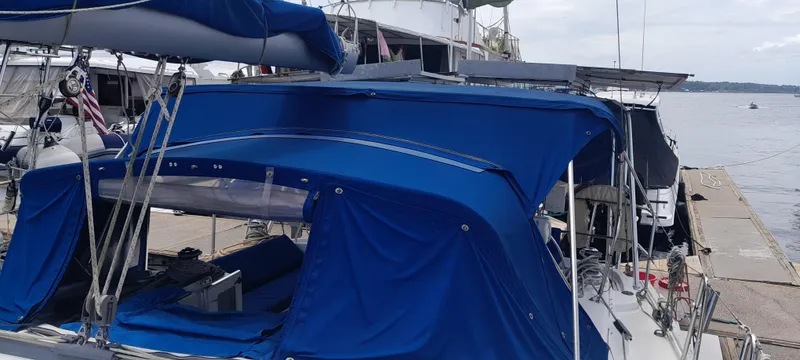 Picaro Yacht Photos Pics 2005 Beneteau Oceanis 473 sailboat with blue canopy docked at marina.