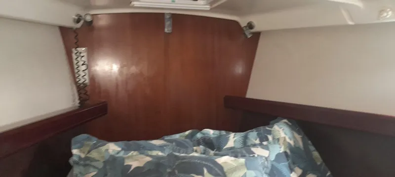 Picaro Yacht Photos Pics Cozy cabin interior of 2005 Beneteau Oceanis 473 sailboat with patterned bedding.