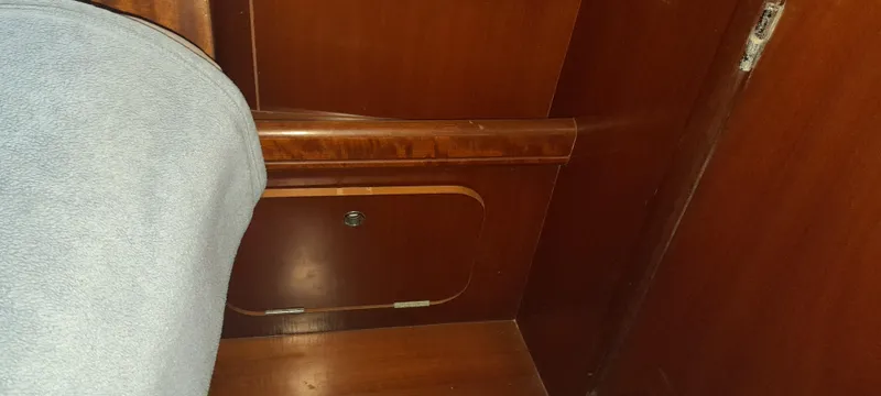 Picaro Yacht Photos Pics Interior cabin detail of 2005 Beneteau Oceanis 473 sailboat, featuring wooden paneling and storage.