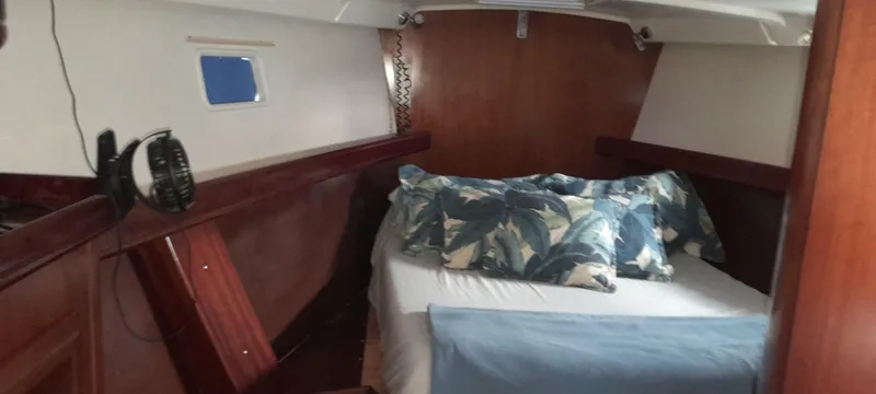 Picaro Yacht Photos Pics Cozy cabin interior of 2005 Beneteau Oceanis 473 sailboat with bed and pillows.