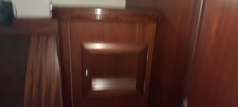 Picaro Yacht Photos Pics Wooden interior of 2005 Beneteau Oceanis 473 yacht, featuring a cabinet.