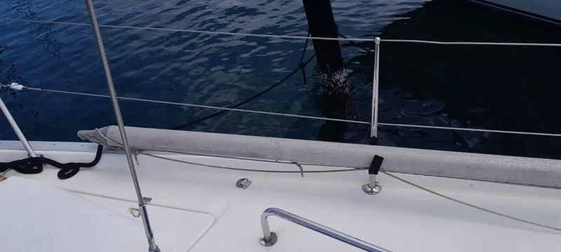 Picaro Yacht Photos Pics Deck view of a 2005 Beneteau Oceanis 473 sailboat, showing railing and calm water.