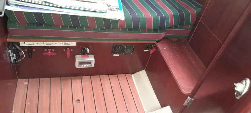 Picaro Yacht Photos Pics Interior of 2005 Beneteau Oceanis 473 sailboat with striped seating and control panel.