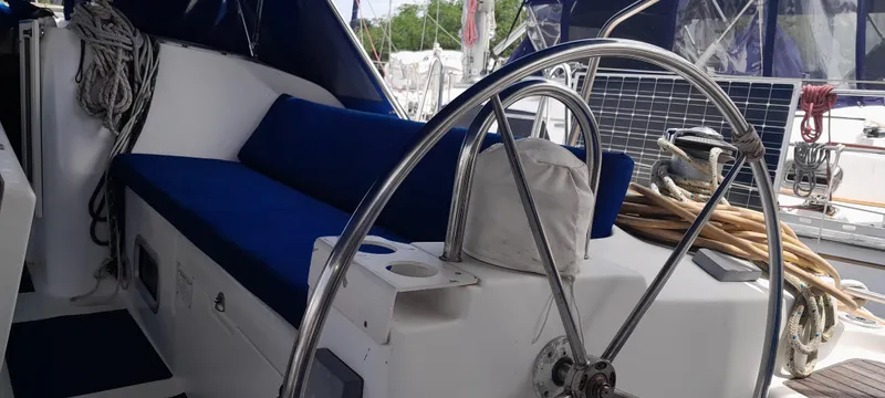 Picaro Yacht Photos Pics 2005 Beneteau Oceanis 473 yacht cockpit with blue seating and steering wheel.