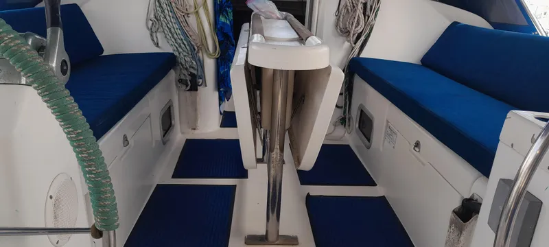 Picaro Yacht Photos Pics Interior of 2005 Beneteau Oceanis 473 sailboat with blue seating and nautical equipment.