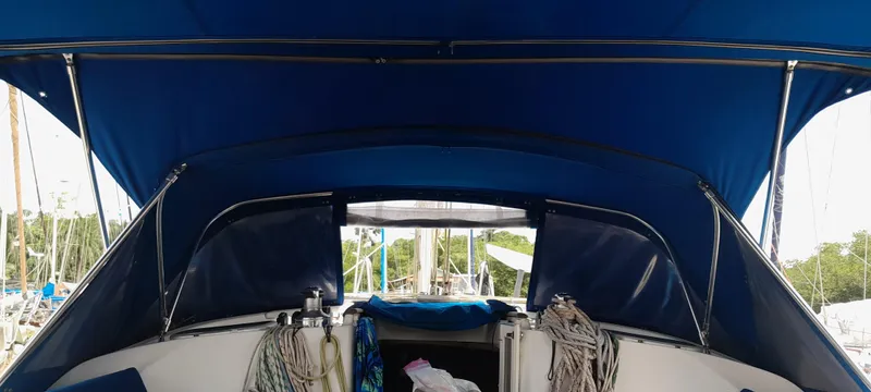 Picaro Yacht Photos Pics 2005 Beneteau Oceanis 473 sailboat cockpit with blue canopy and ropes.