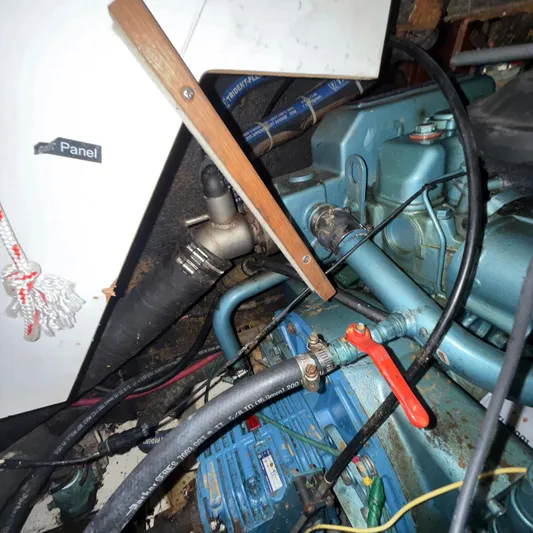 Picaro Yacht Photos Pics Engine compartment of a 2005 Beneteau Oceanis 473 sailboat, showing hoses and components.